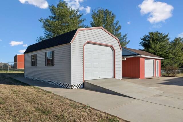 detached garage featuring fence