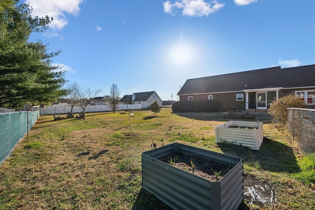 view of yard with a vegetable garden and fence