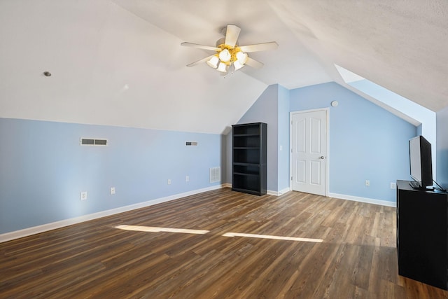 bonus room with lofted ceiling with skylight, wood finished floors, visible vents, and baseboards