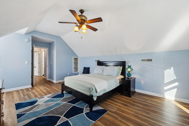 bedroom featuring vaulted ceiling, wood finished floors, visible vents, and baseboards