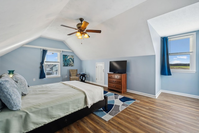 bedroom with lofted ceiling, ceiling fan, baseboards, and wood finished floors