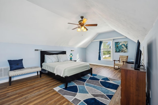 bedroom with visible vents, vaulted ceiling, baseboards, and wood finished floors