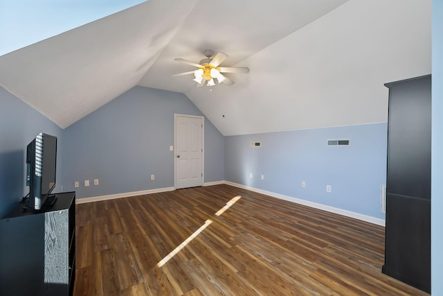 additional living space featuring lofted ceiling, wood finished floors, visible vents, baseboards, and a ceiling fan