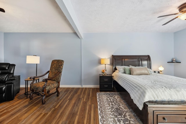 bedroom with baseboards, a ceiling fan, dark wood-style floors, a textured ceiling, and beam ceiling