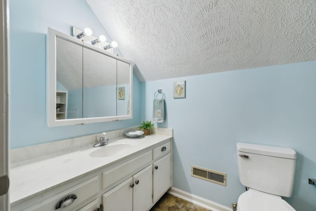 bathroom with visible vents, lofted ceiling, toilet, a textured ceiling, and vanity