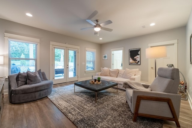 living room with recessed lighting, wood finished floors, and french doors