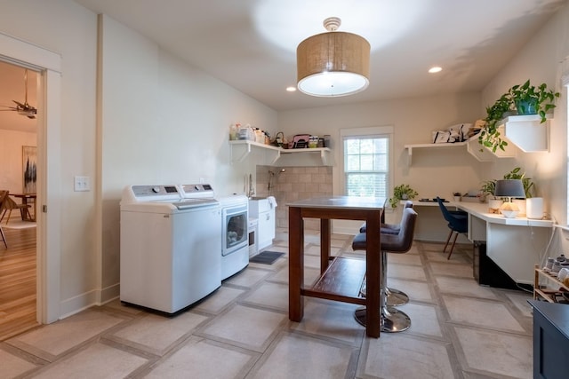 laundry area with washing machine and clothes dryer and recessed lighting