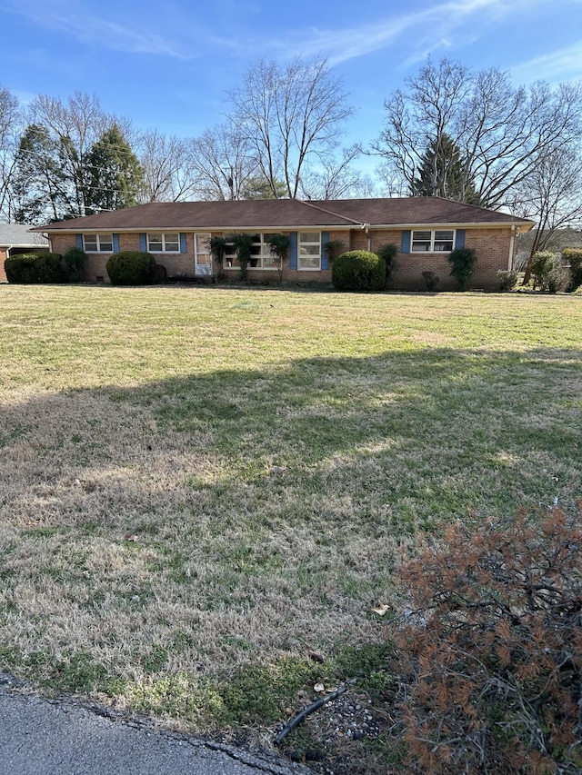 ranch-style home featuring a front yard and brick siding