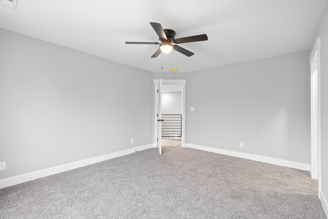 unfurnished room featuring a ceiling fan, carpet flooring, and baseboards