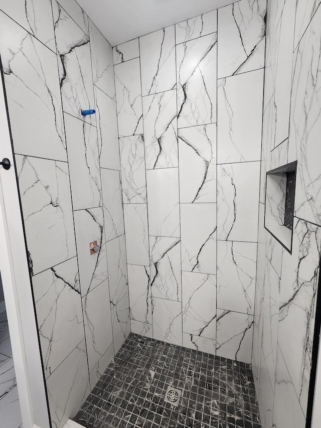 full bath featuring a tile shower