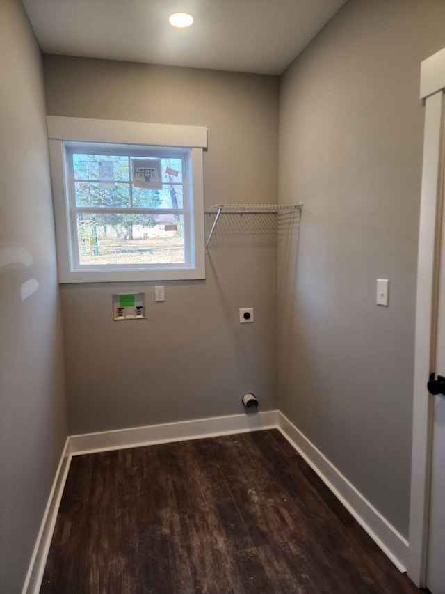 washroom featuring dark wood-type flooring, washer hookup, laundry area, and baseboards