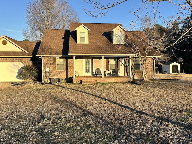 new england style home featuring a patio area, a shingled roof, and brick siding