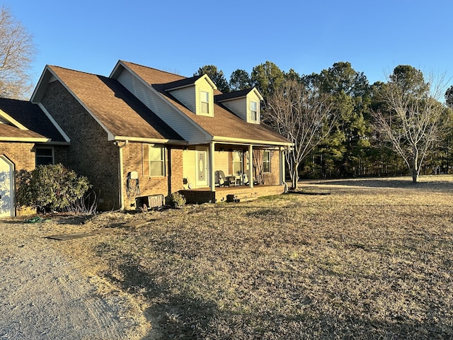 view of front of house with a patio and brick siding