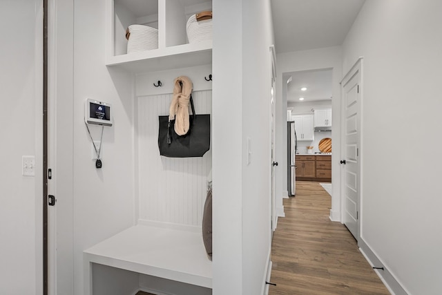 mudroom with baseboards and wood finished floors