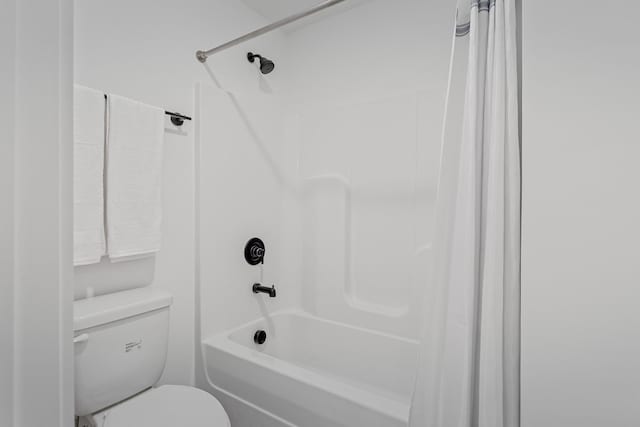 bathroom featuring shower / bathtub combination with curtain and toilet