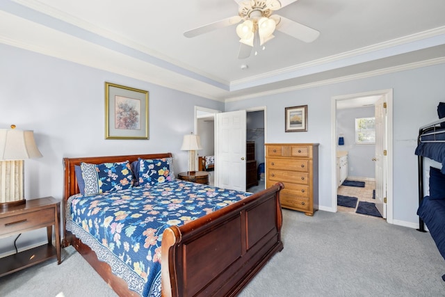 bedroom with baseboards, light colored carpet, a spacious closet, crown molding, and a closet