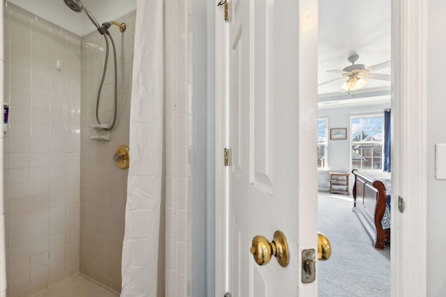 full bathroom featuring ceiling fan and tiled shower