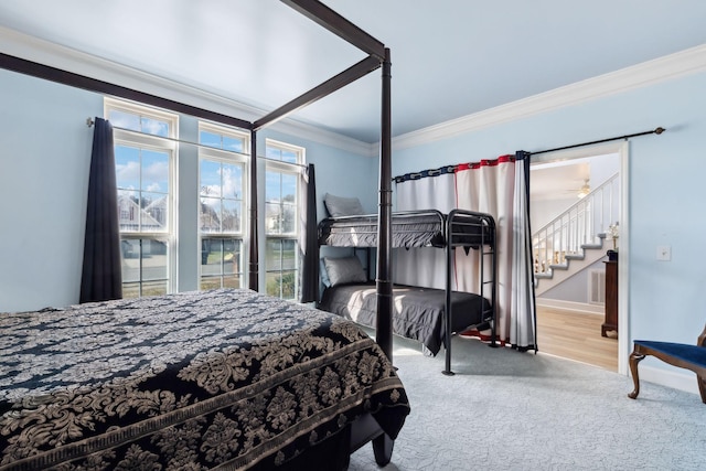 bedroom with baseboards, carpet flooring, connected bathroom, and crown molding