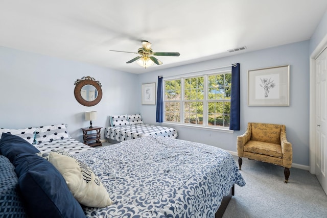 carpeted bedroom with a closet, visible vents, ceiling fan, and baseboards