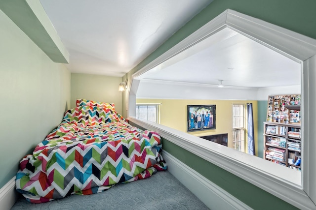 bedroom featuring multiple windows and carpet