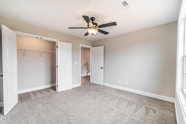 unfurnished bedroom with carpet floors, a closet, visible vents, a ceiling fan, and baseboards