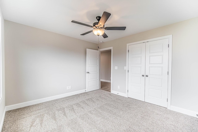 unfurnished bedroom featuring carpet floors, a closet, ceiling fan, and baseboards