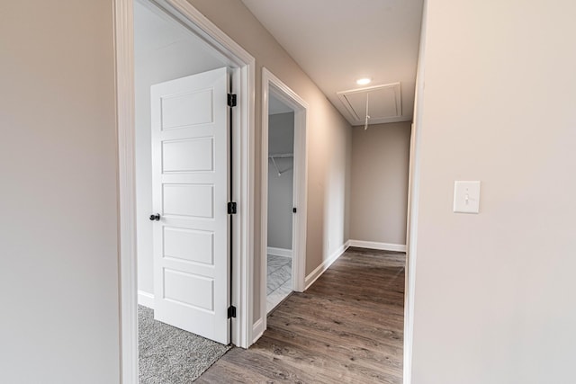 hallway with attic access, recessed lighting, baseboards, and wood finished floors