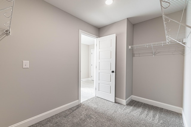 unfurnished bedroom featuring carpet flooring and baseboards