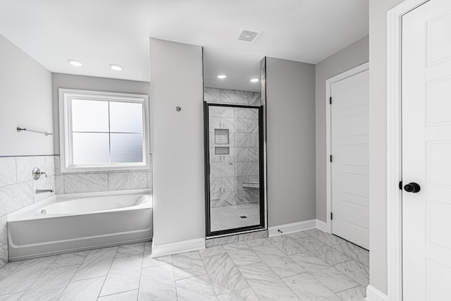 bathroom with marble finish floor, a garden tub, visible vents, a shower stall, and baseboards