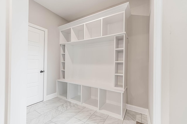 mudroom featuring marble finish floor and baseboards