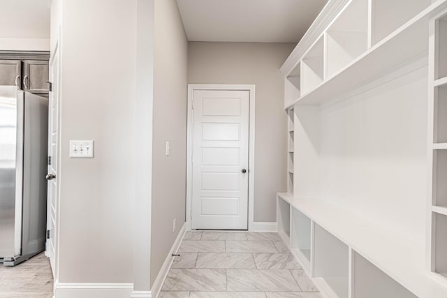 mudroom featuring marble finish floor and baseboards