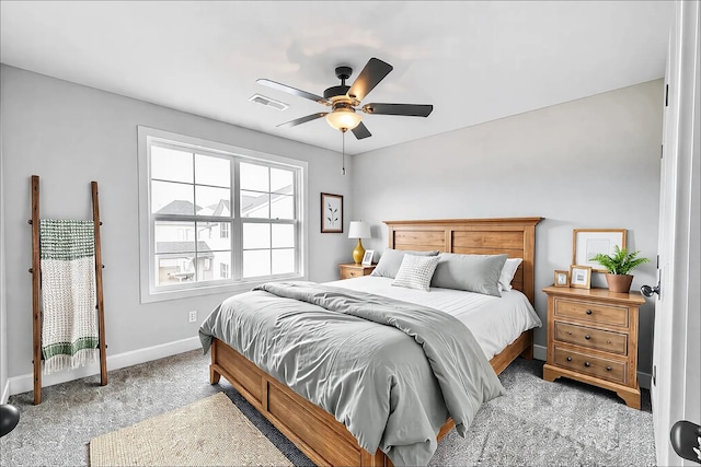 bedroom with a ceiling fan, light colored carpet, visible vents, and baseboards