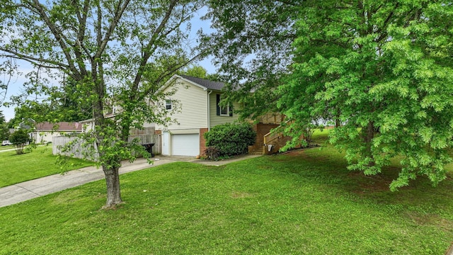 exterior space with a garage, driveway, brick siding, and a front yard