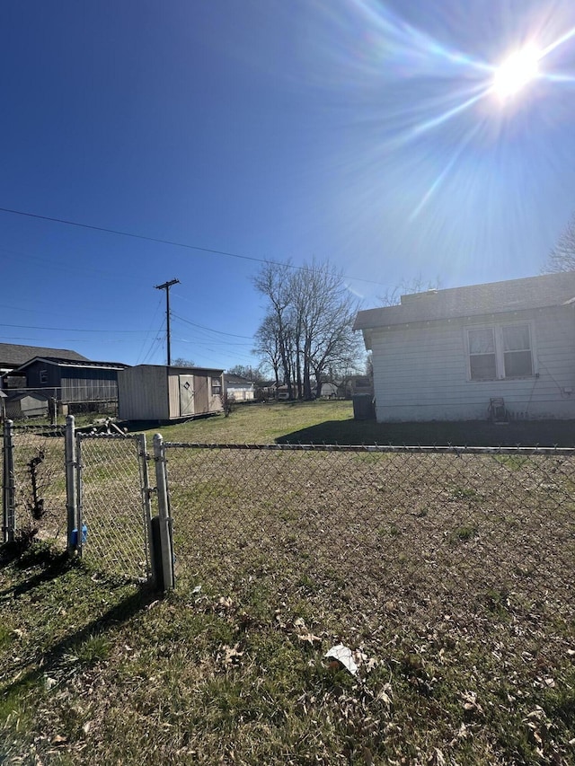 view of yard with fence and an outbuilding