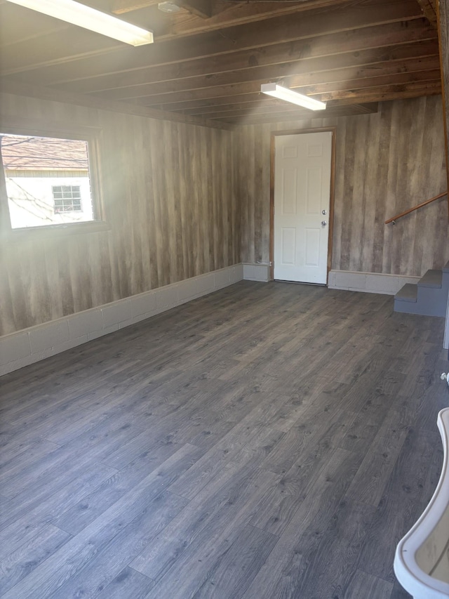 basement featuring stairway and dark wood-type flooring