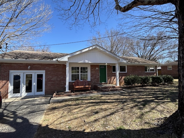 view of front of house with french doors and brick siding