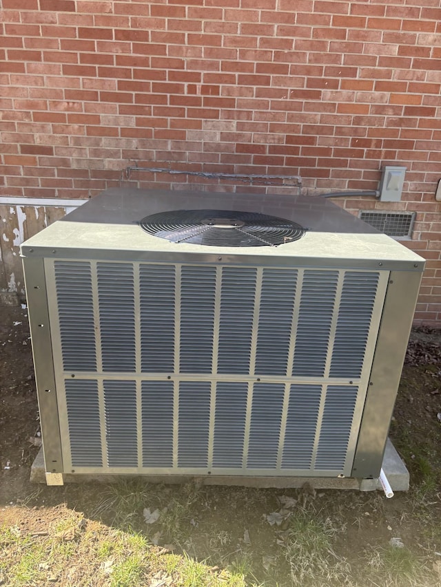 exterior details with central AC unit and brick siding