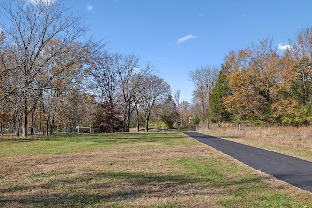 exterior space with fence and a lawn