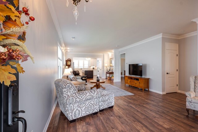 living area featuring ornamental molding, dark wood-style flooring, and baseboards