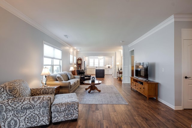 living room featuring dark wood-style flooring, visible vents, crown molding, and baseboards