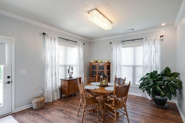 dining space featuring hardwood / wood-style flooring, plenty of natural light, visible vents, and ornamental molding