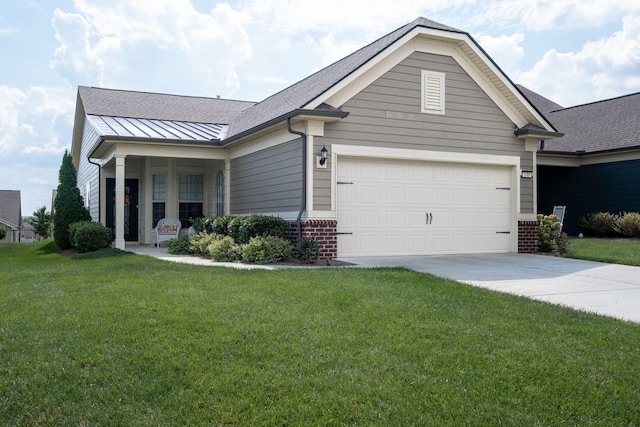 view of front of property with a garage, a standing seam roof, a front yard, and brick siding