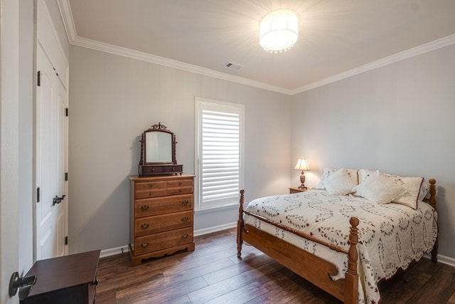 bedroom featuring baseboards, crown molding, visible vents, and hardwood / wood-style floors