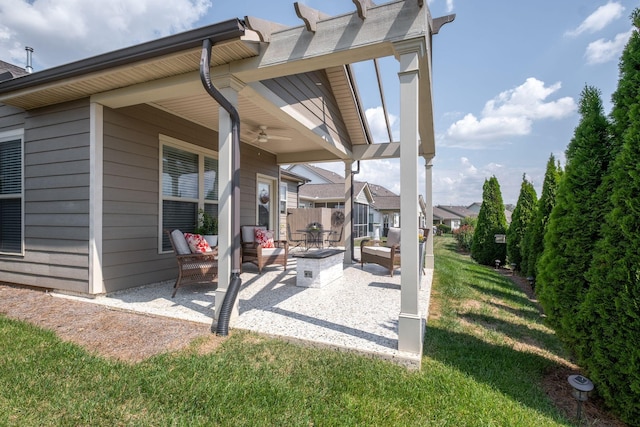 view of patio with a ceiling fan, an outdoor fire pit, and fence