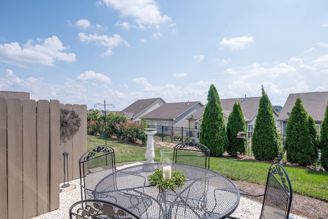 view of patio with a residential view, outdoor dining area, and fence