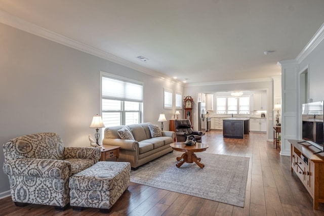 living area featuring ornamental molding, dark wood-style flooring, and visible vents