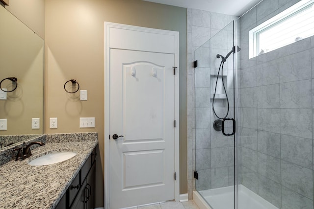 bathroom featuring a stall shower and vanity