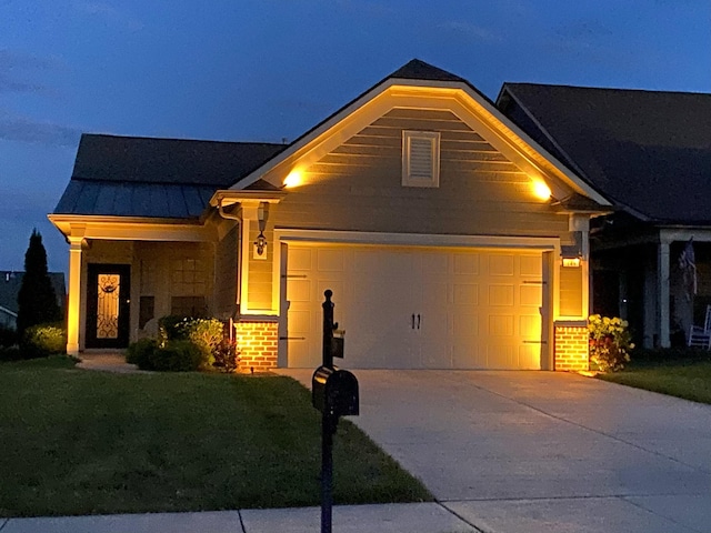 view of front of home featuring driveway, metal roof, an attached garage, a standing seam roof, and brick siding