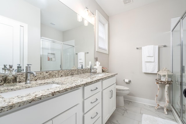 bathroom with marble finish floor, baseboards, a stall shower, and a sink