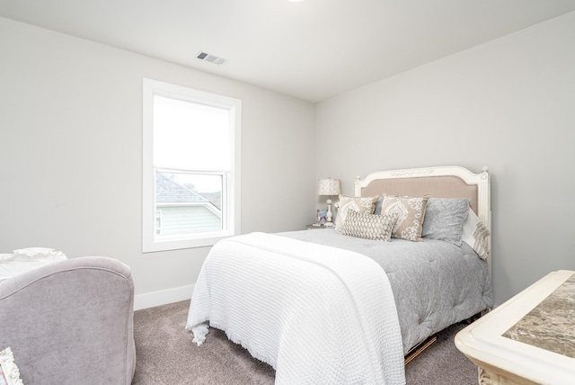carpeted bedroom with baseboards and visible vents